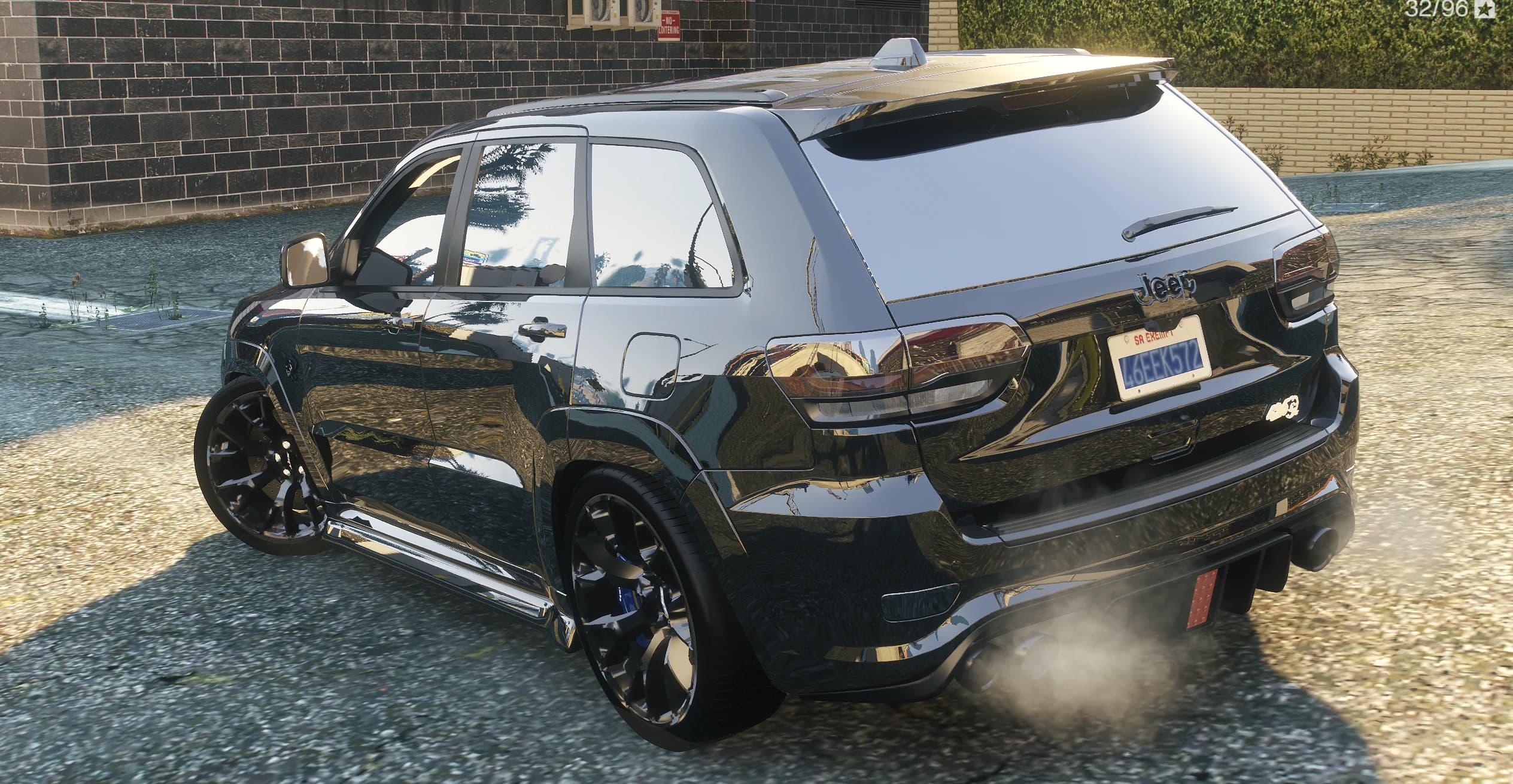 Rear view of the Grand Cherokee with tinted taillights, the Jeep badge and smoke from the diffuser exhausts