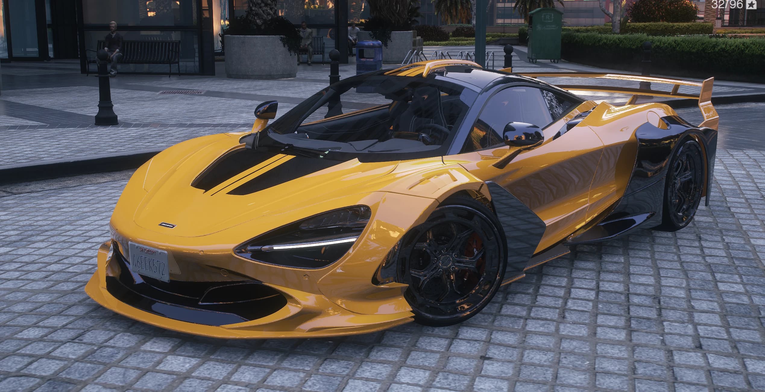 Yellow McLaren 720s Zacoe Widebody parked on a cobbled plaza with the GT wing in view