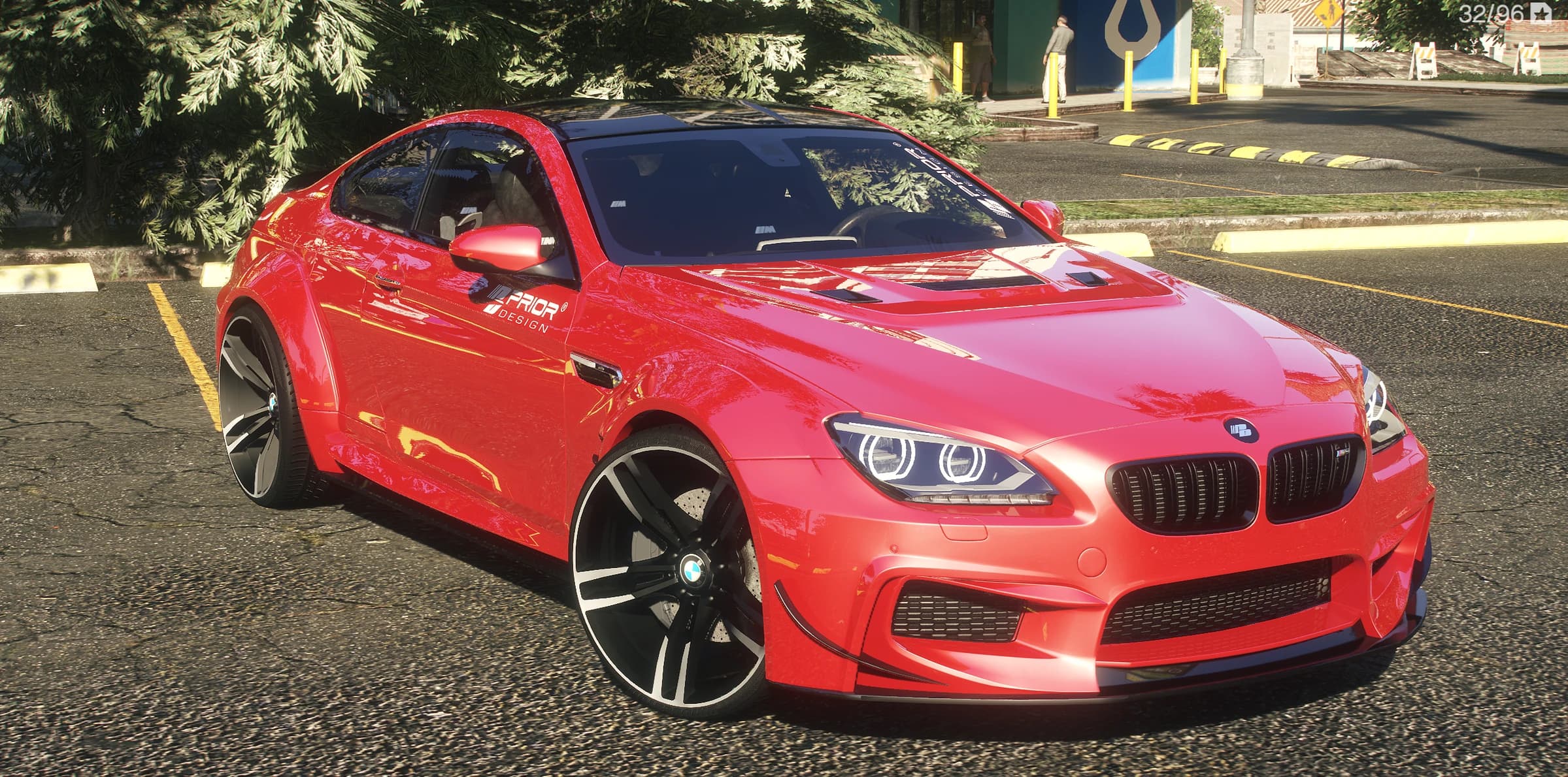 Front three quarter view of the red BMW M6 with the Prior Design widebody kit and angel eye headlights