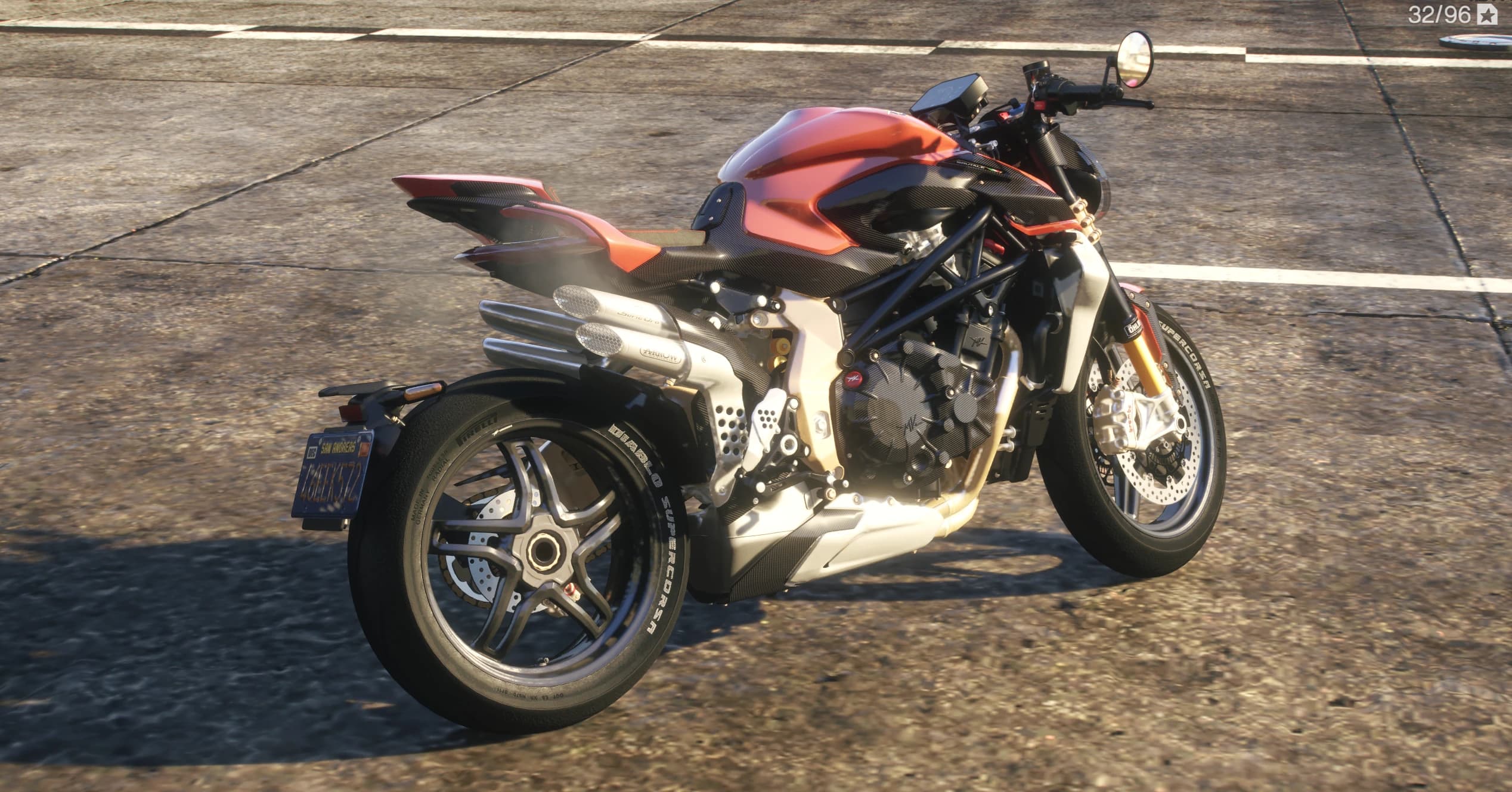 Rear three quarter view showing the four stacked exhaust tips, single sided swingarm, Pirelli lettered tyre and carbon tail