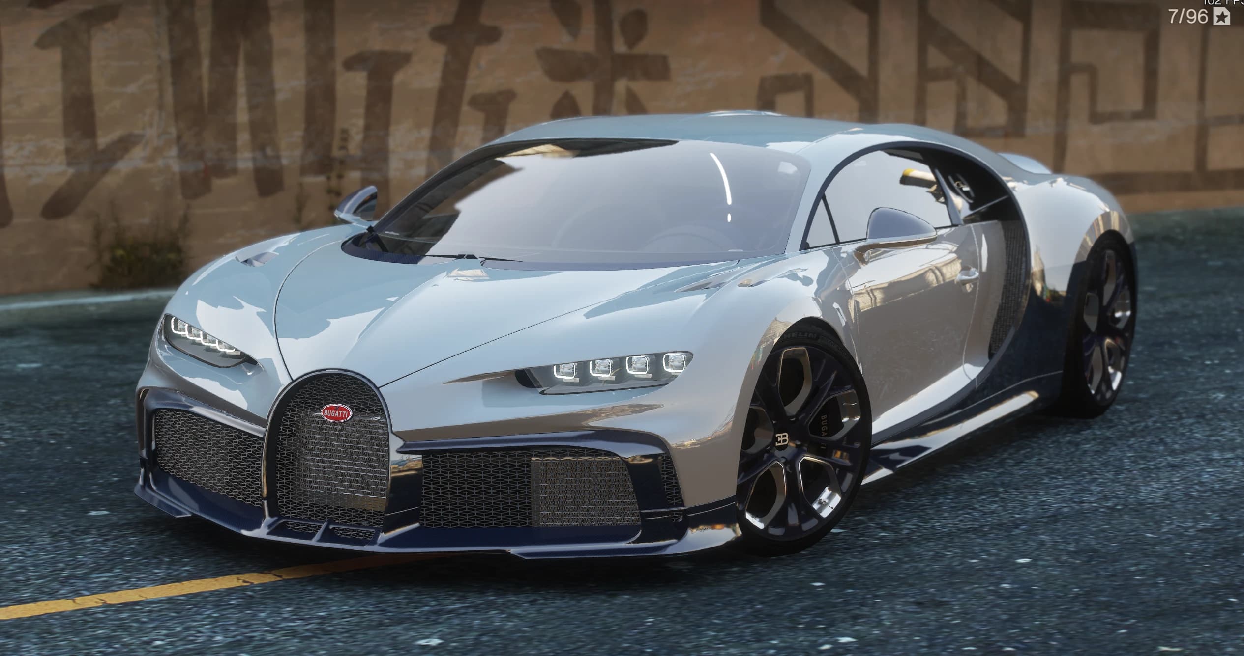 Close front view of the Chiron Profilee showing the carbon front splitter, both quad-LED headlight clusters and the gold and black alloy wheels