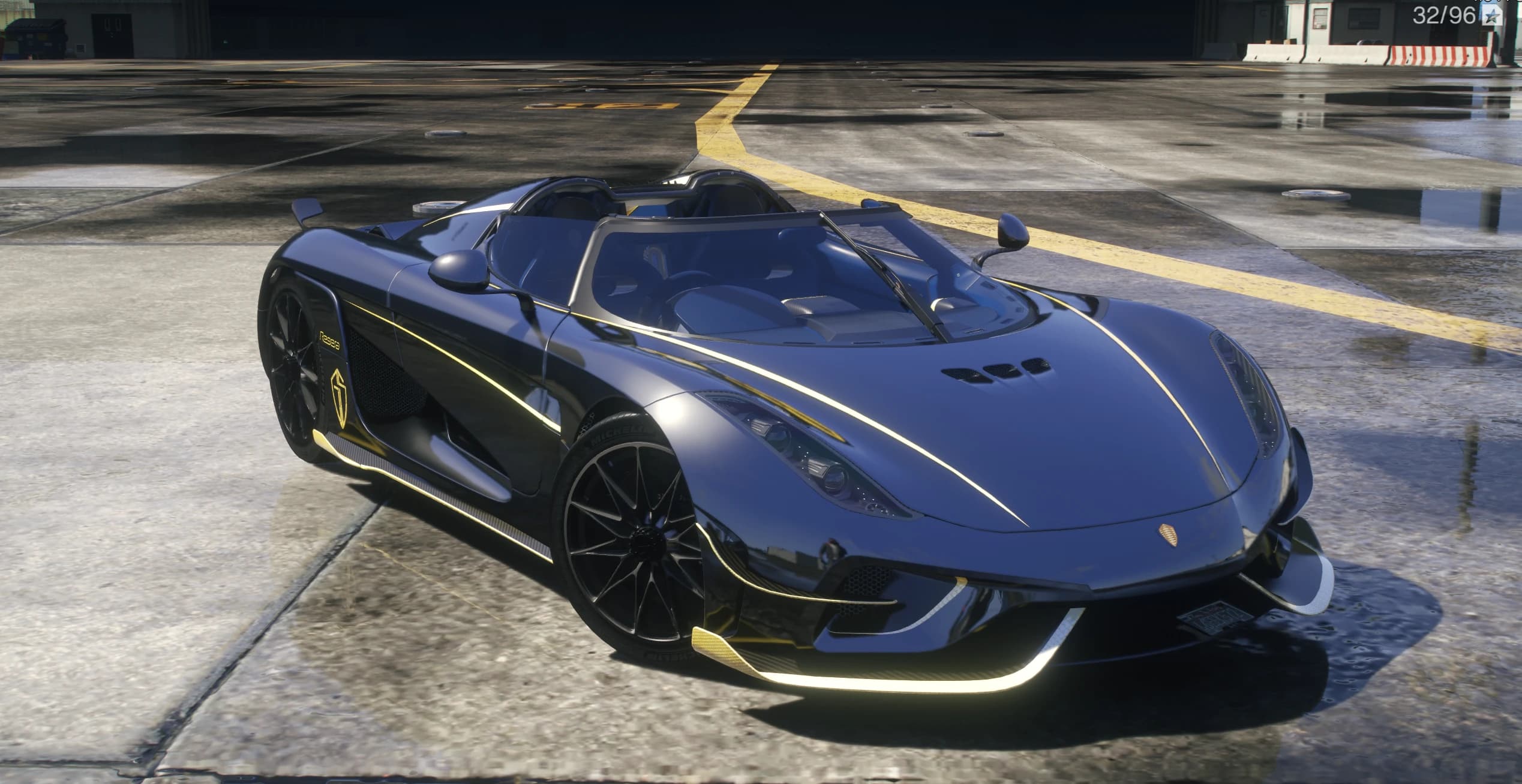Front three quarter view of the Regera with the roof removed showing the blue interior