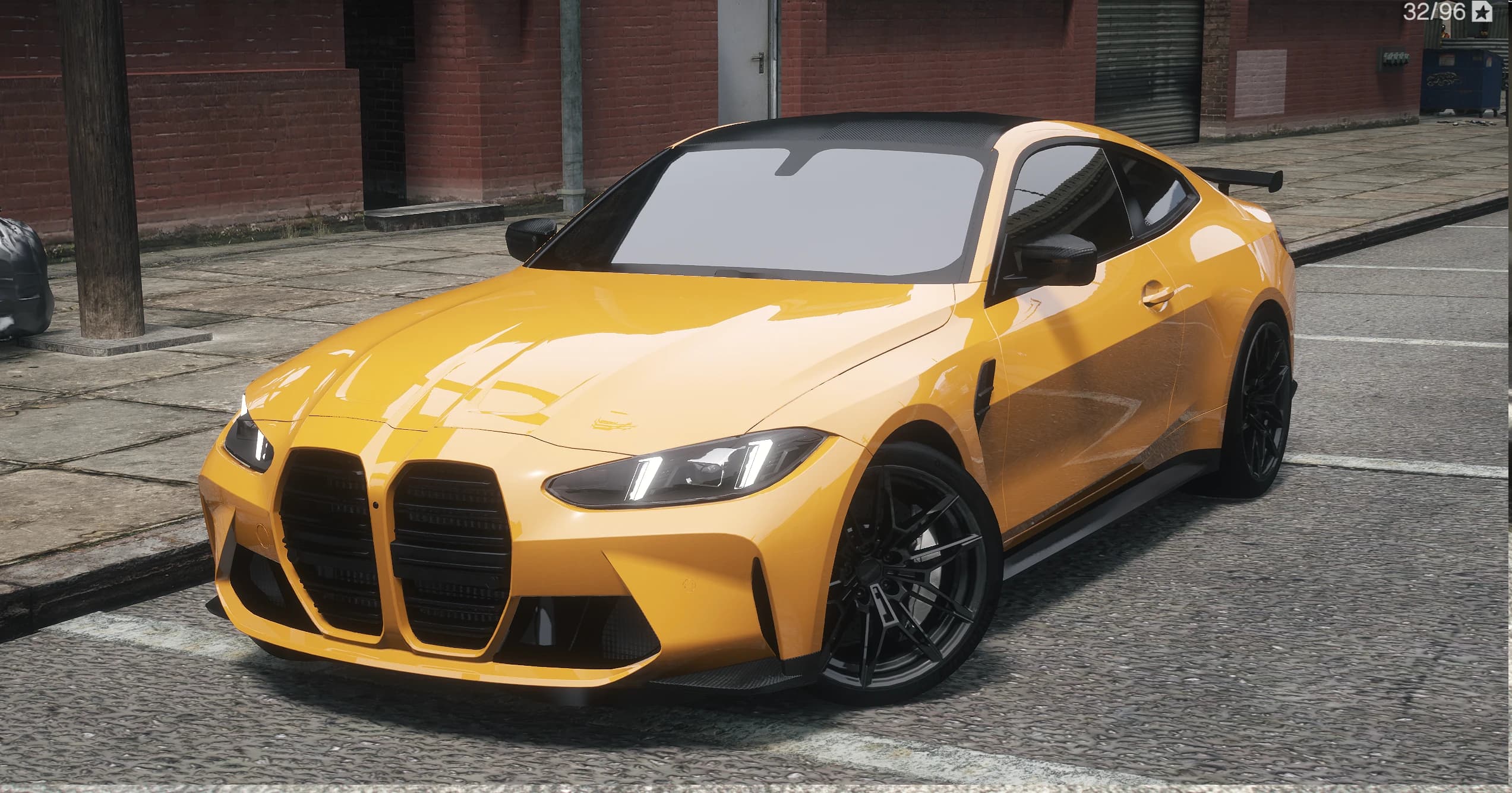Front three quarter view of the golden orange BMW M4 G82 with the tall kidney grilles, carbon roof and black wheels