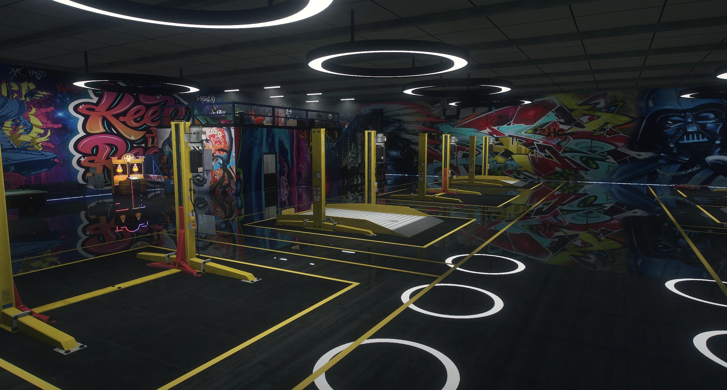 Wide view of the workshop floor with yellow two post lifts, ring lights and a mezzanine office