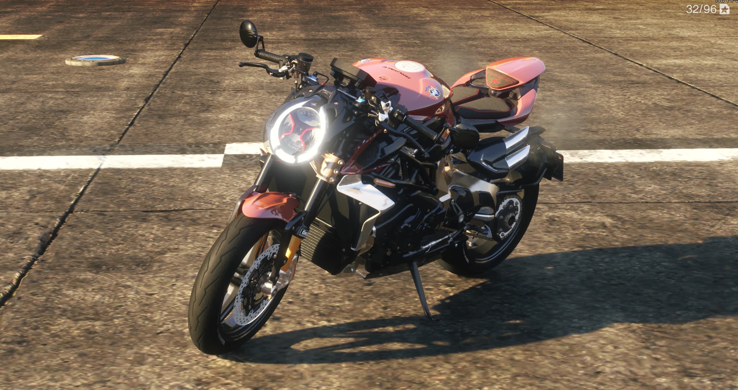 Front three quarter view of the red and black MV Agusta Brutale 1000 Serie Oro with its round LED headlight ring lit and carbon front fender