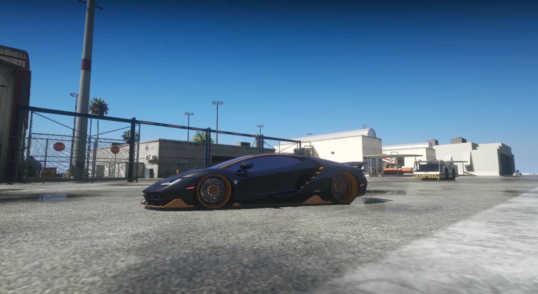 Low side profile at the airfield showing the roofless body, orange sill accents and the wire like spokes of the Rucci wheels