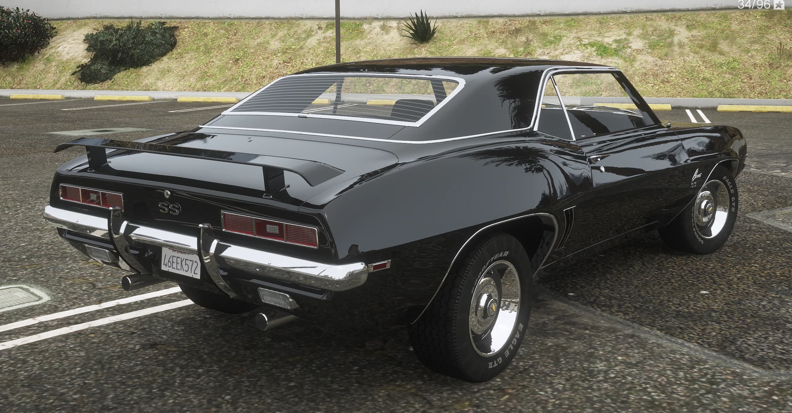 Rear three quarter view of the Camaro SS showing the ducktail spoiler, the SS tail panel badge and the chrome rear bumper