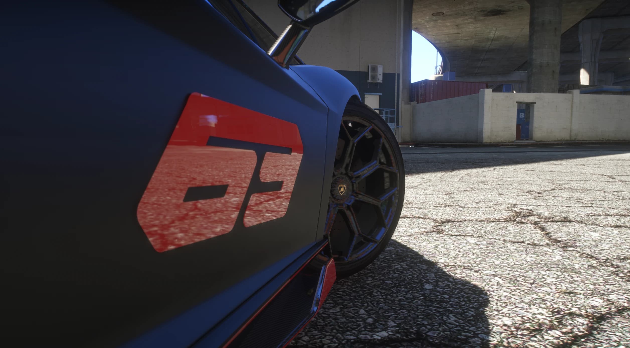 Close up of the red 63 door graphic over the black hexagon spoke wheel, carbon skirt and red coachline
