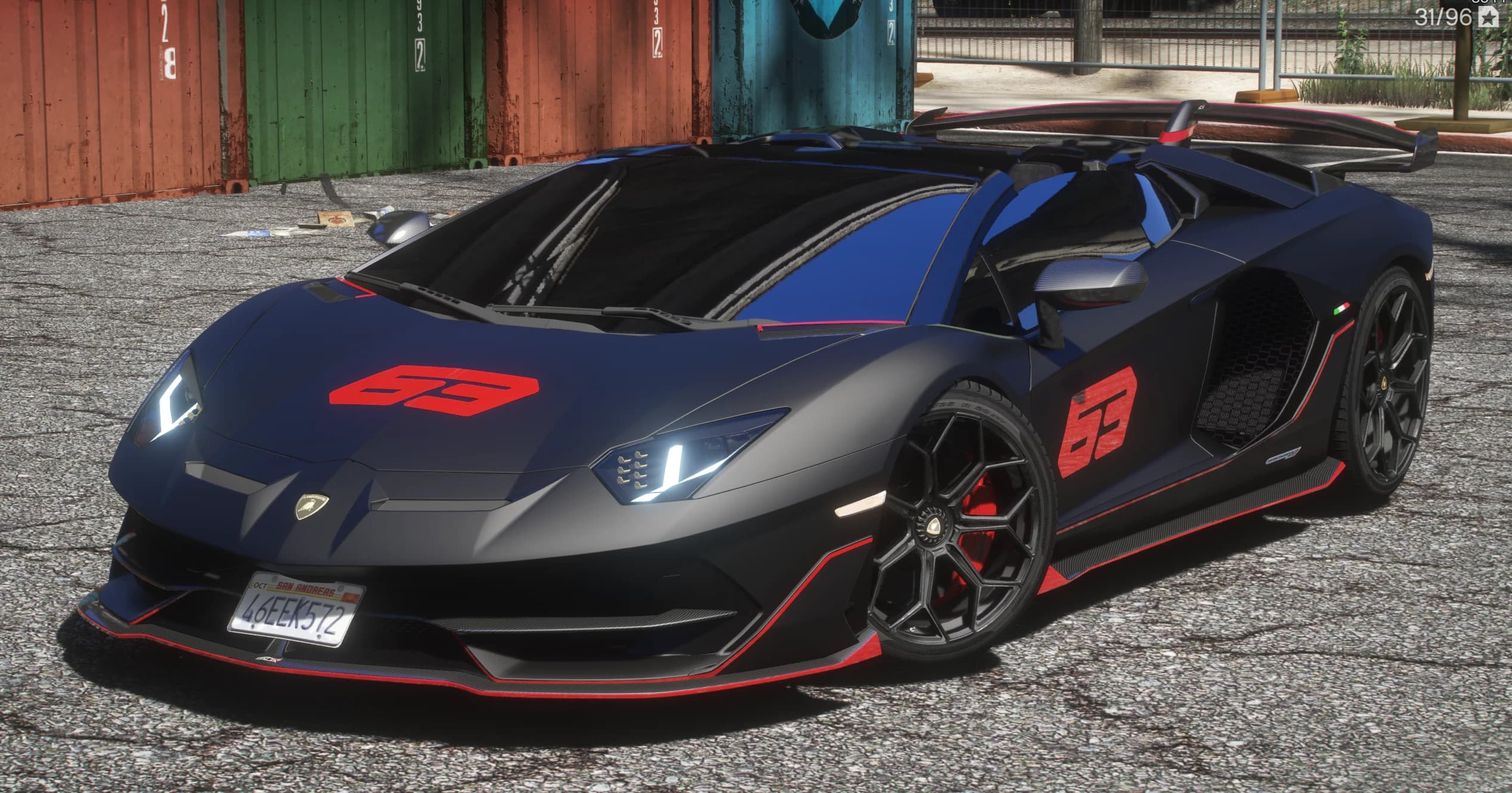 Front three quarter view of the matte black SVJ 63 Roadster with red 63 graphics on the hood and door, roof off and red edged canards