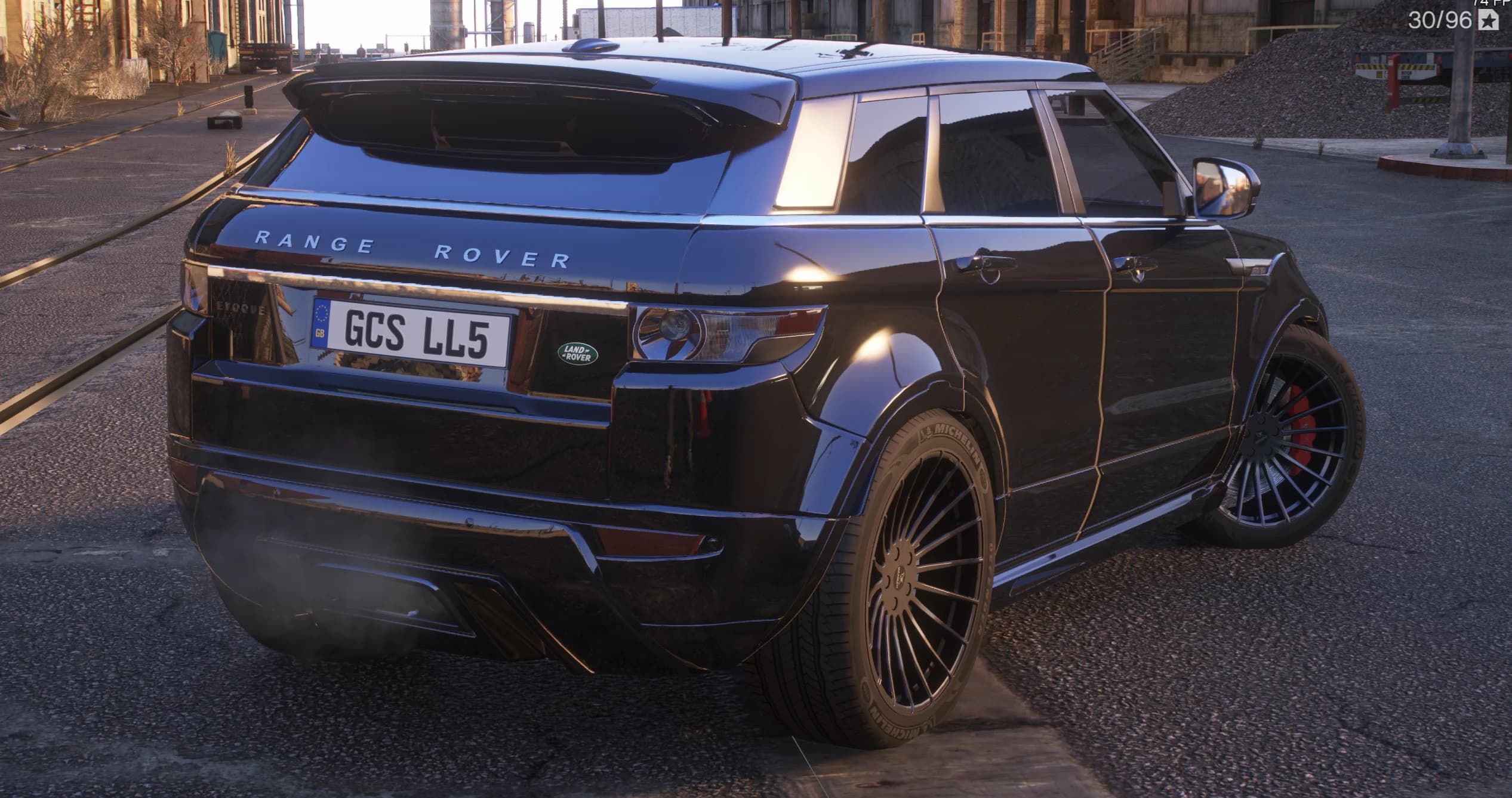 Rear view showing the roof spoiler, the diffuser with twin exhausts, red brake calipers and the RANGE ROVER lettering across the tailgate