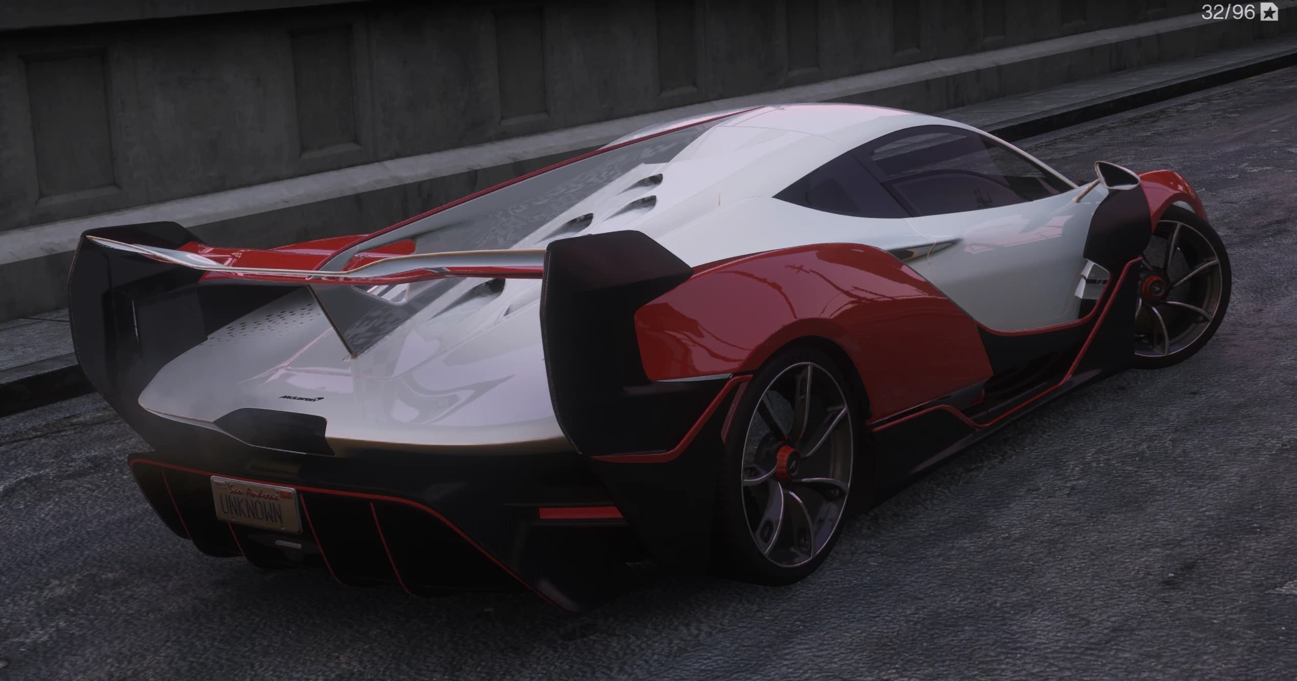 Rear three quarter view of the Sabre showing the perforated engine cover, the huge wing and red diffuser fins