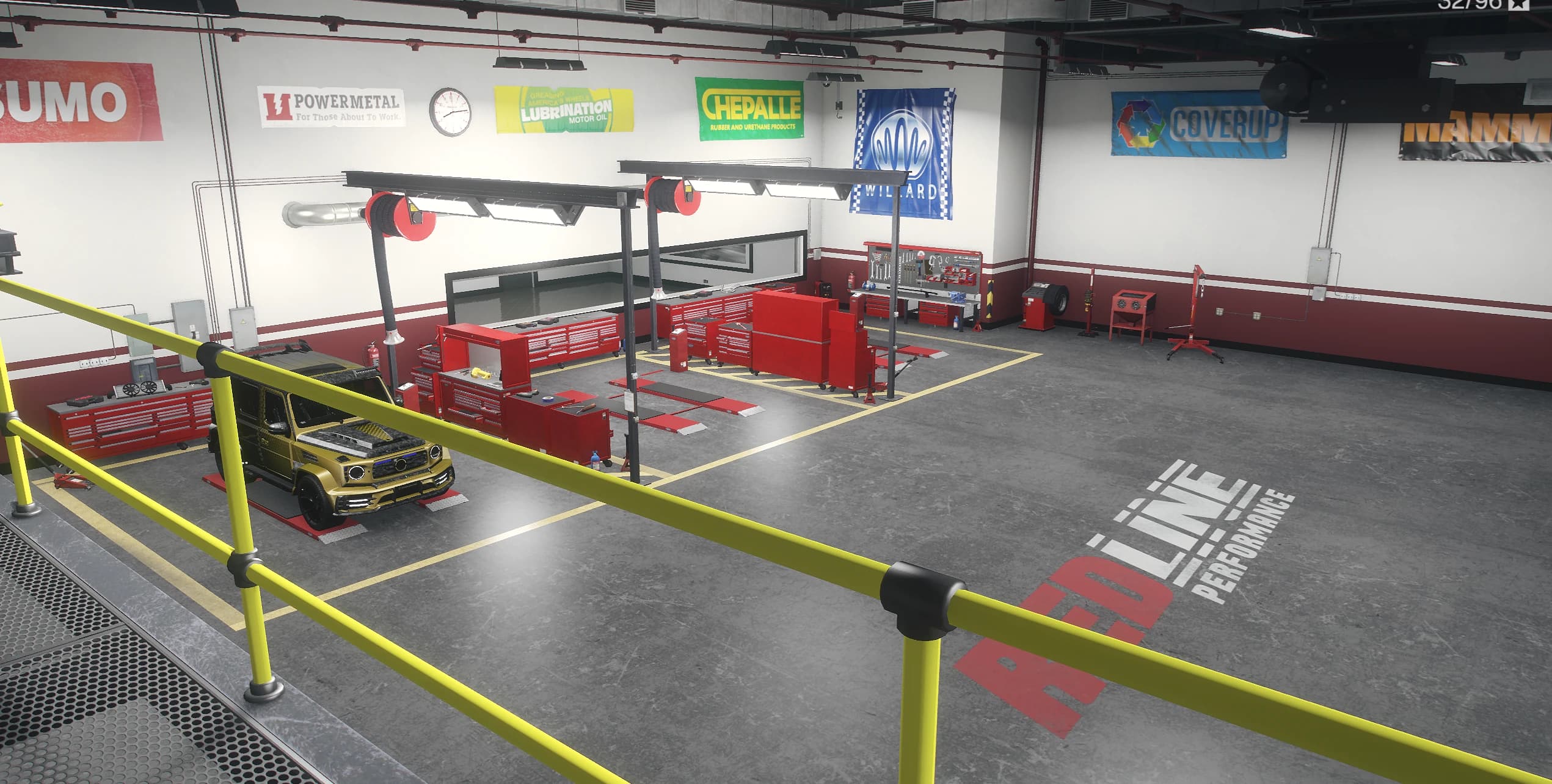 Workshop interior with two work bays, red tool cabinets, sponsor banners and a gold SUV on the lift pad