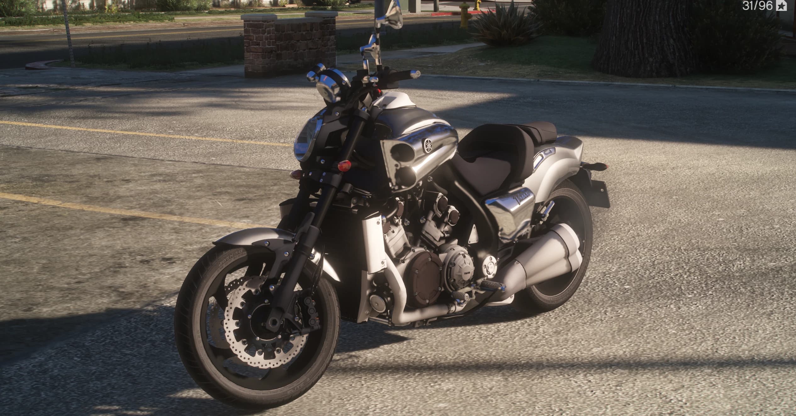 Front three quarter view of the black V-MAX with its chrome intake scoops, round headlight and twin front discs on a suburban street