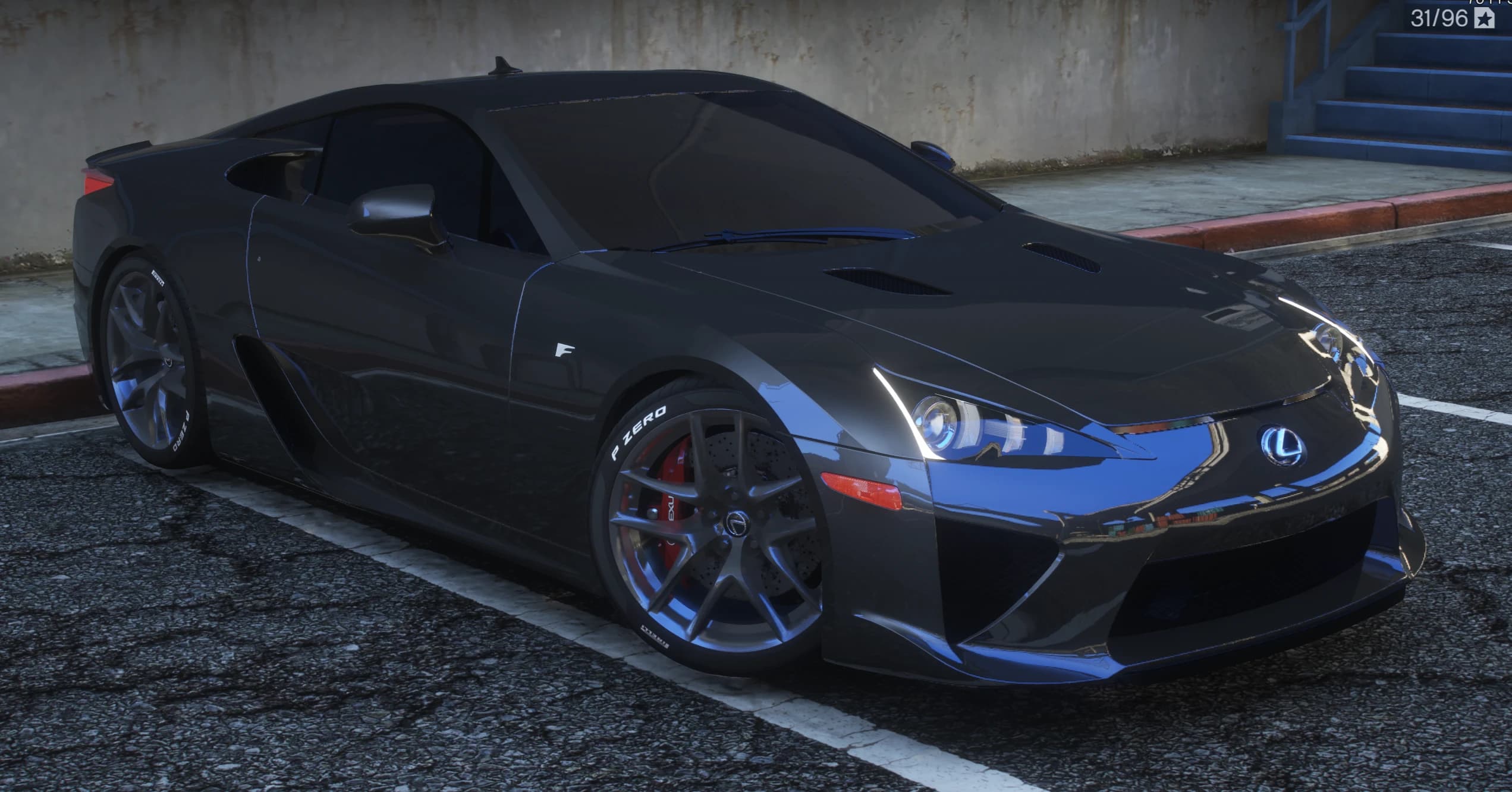 Front three quarter view of the dark grey Lexus LFA with hood vents, the F fender badge and red Lexus calipers behind Y spoke wheels