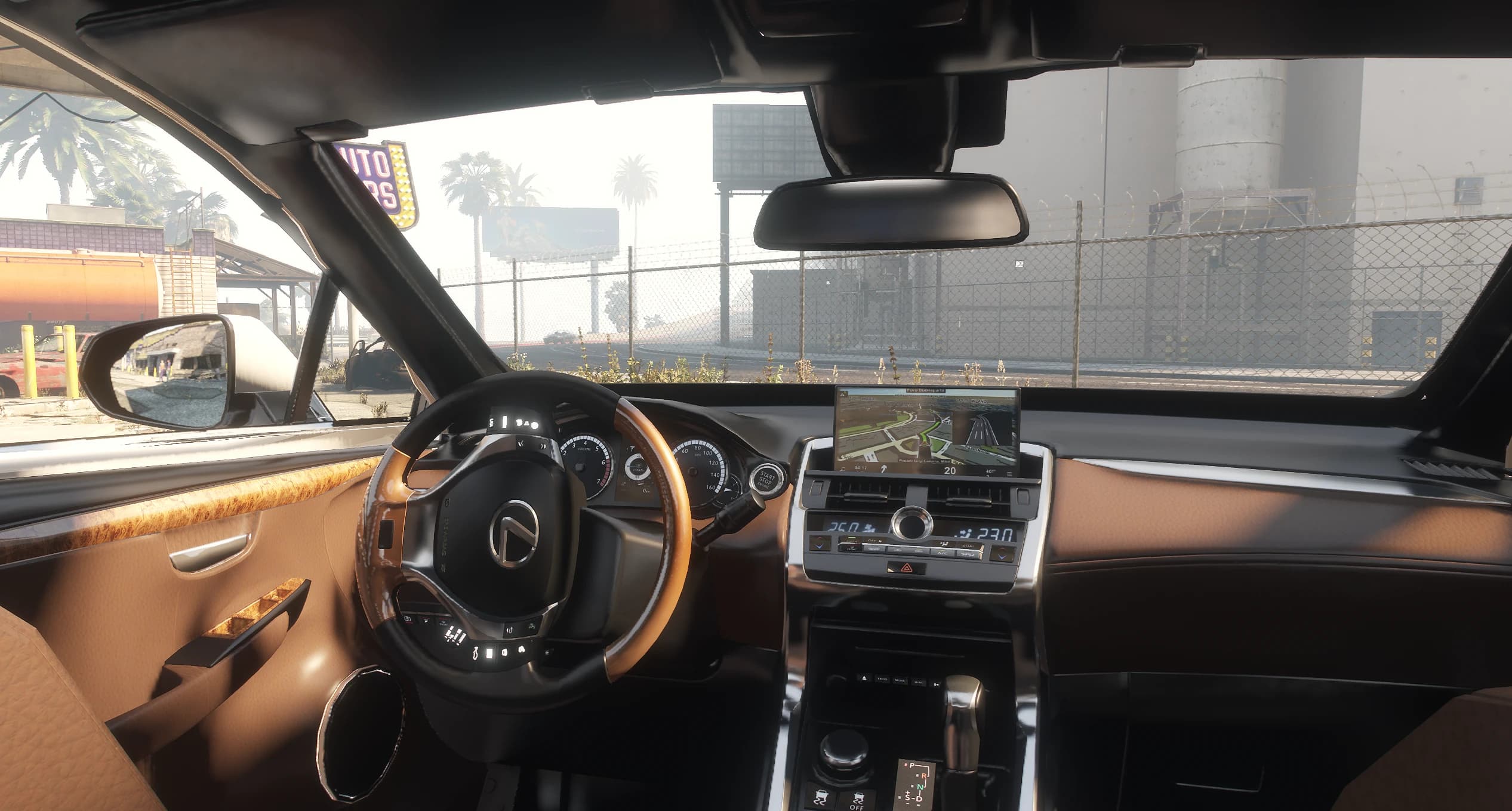 Interior of the RX 450h with caramel leather, wood trimmed steering wheel and the navigation screen