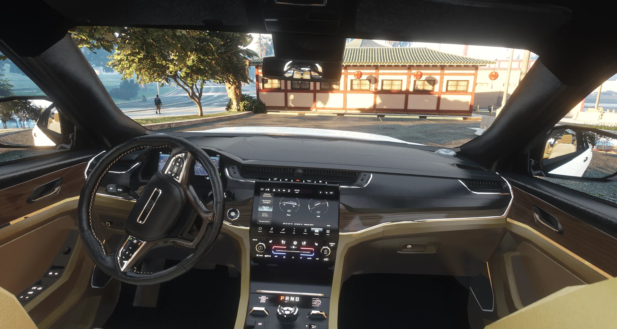 Interior of the Grand Cherokee in black over tan with wood trim, digital cluster and the touchscreen showing off road pages
