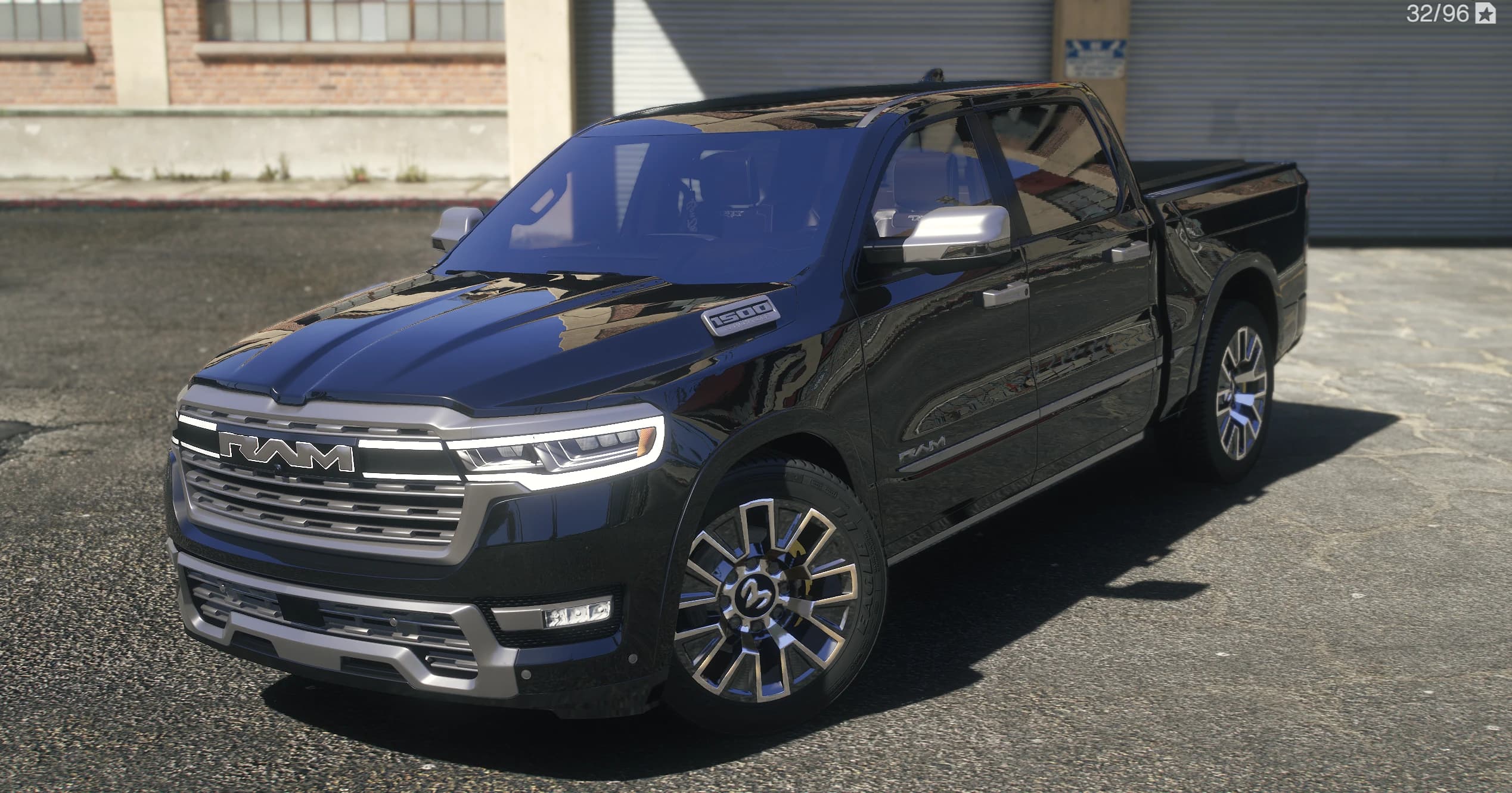 Front three quarter view of the black Ram crew cab with the illuminated RAM grille lettering and polished multi spoke wheels