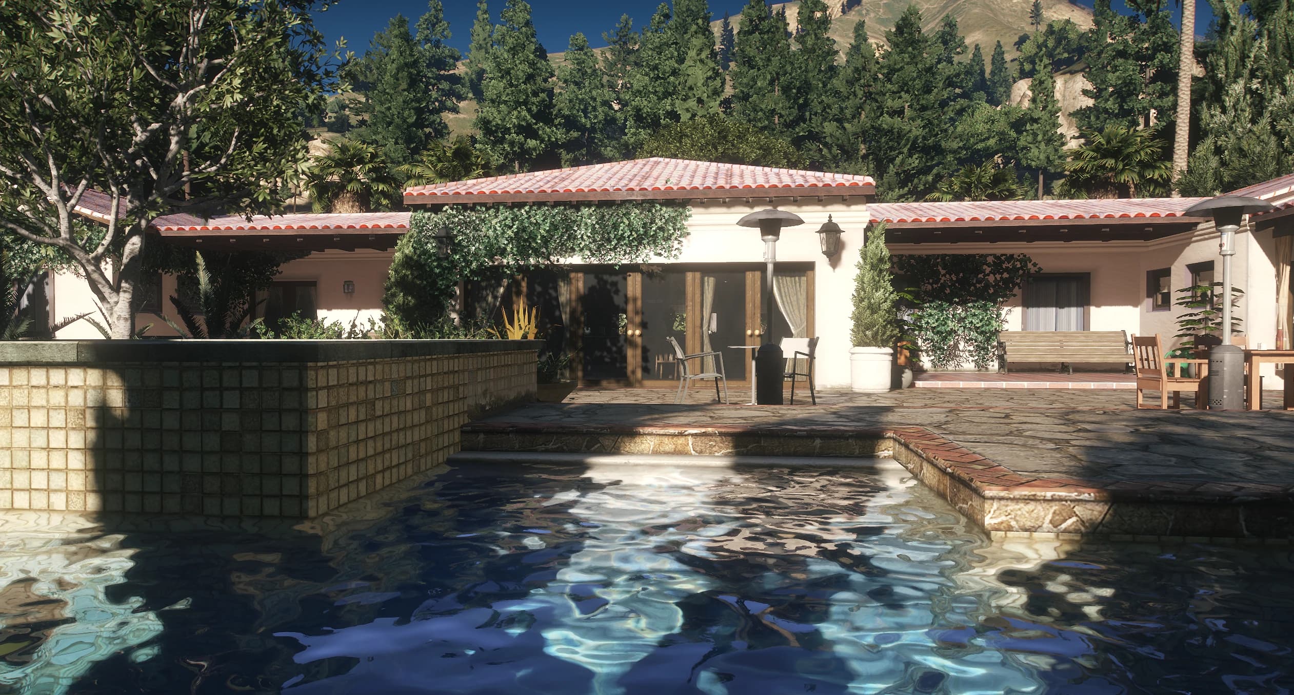 Pool terrace with the vine covered pool house and patio furniture