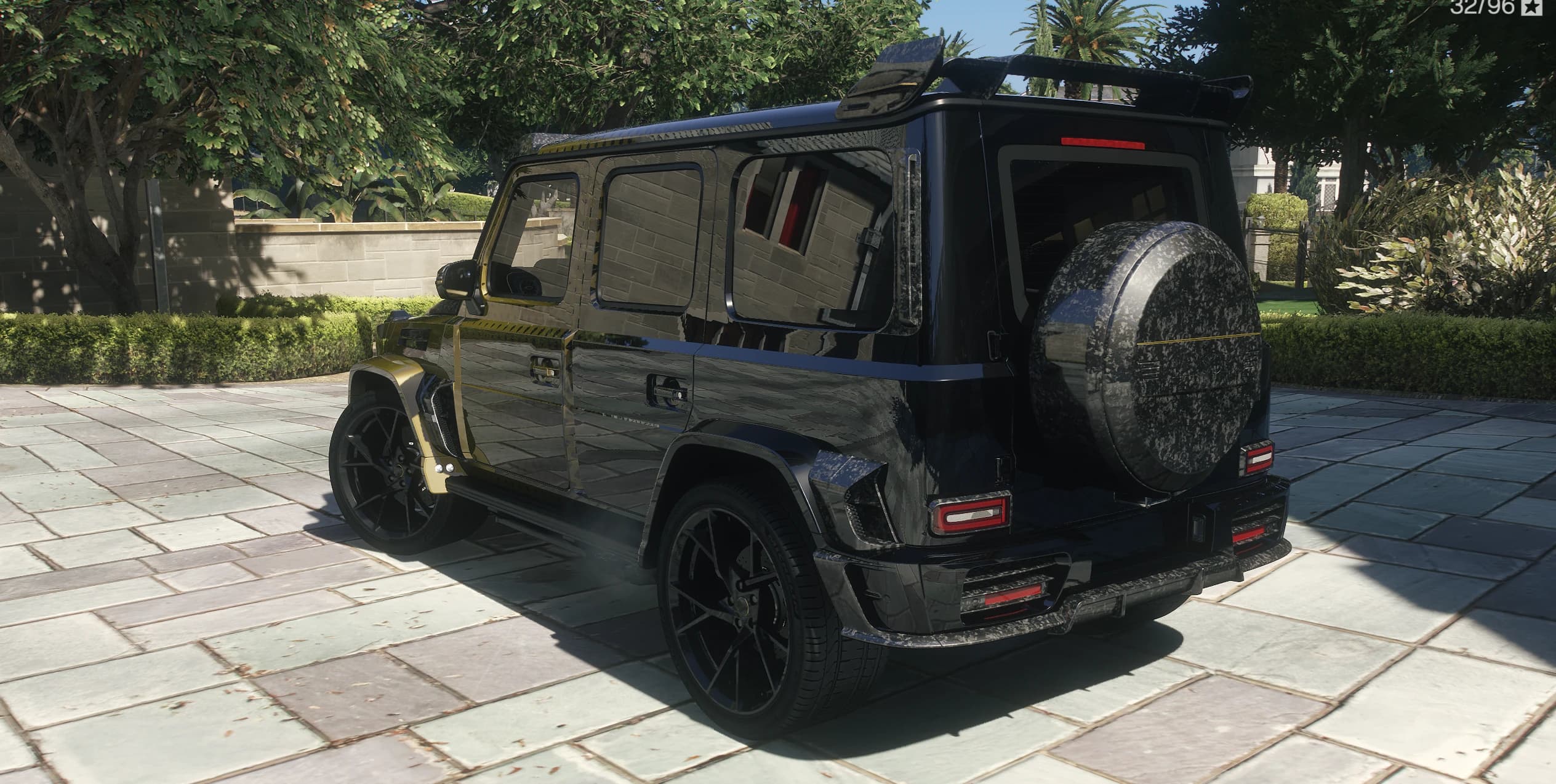 Rear view of the Mansory G63 with the forged carbon spare wheel cover and roof spoiler