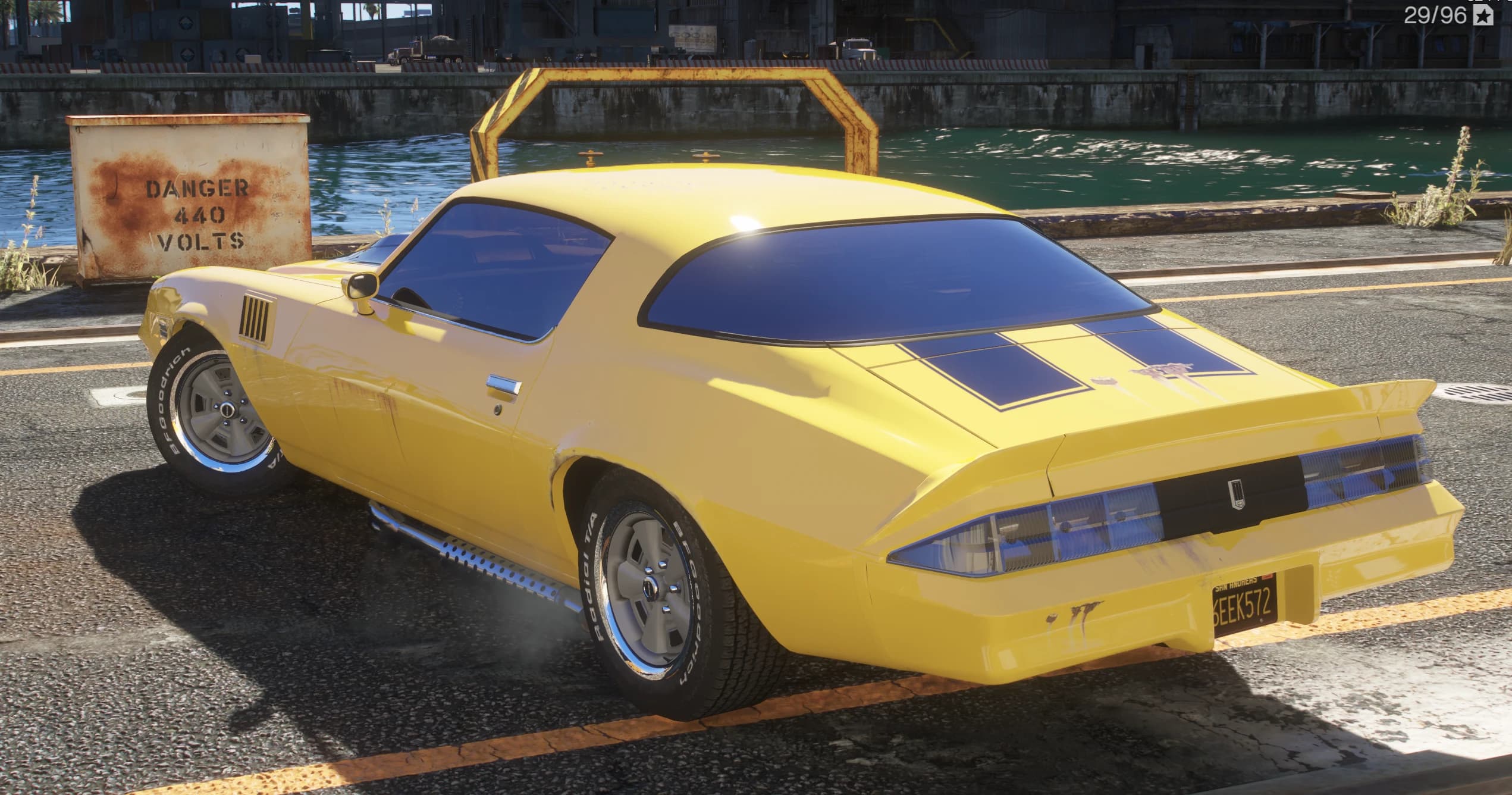 Rear three quarter view at the docks showing the ducktail spoiler, the blacked out tail panel and the chrome side pipes
