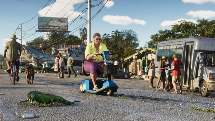 A busy Vice City street with pedestrians, cyclists, a city bus and a woman on a mobility scooter, with an iguana crossing the road