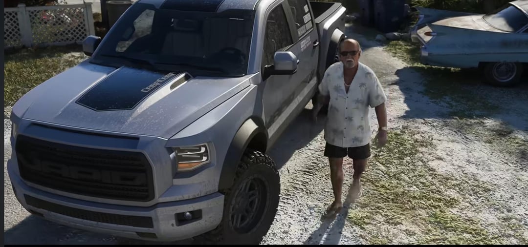 A muddy silver Vapid offroad pickup truck parked in a gravel yard in GTA 6, a man in a palm-print shirt walking beside it and a classic Cadillac visible in the background